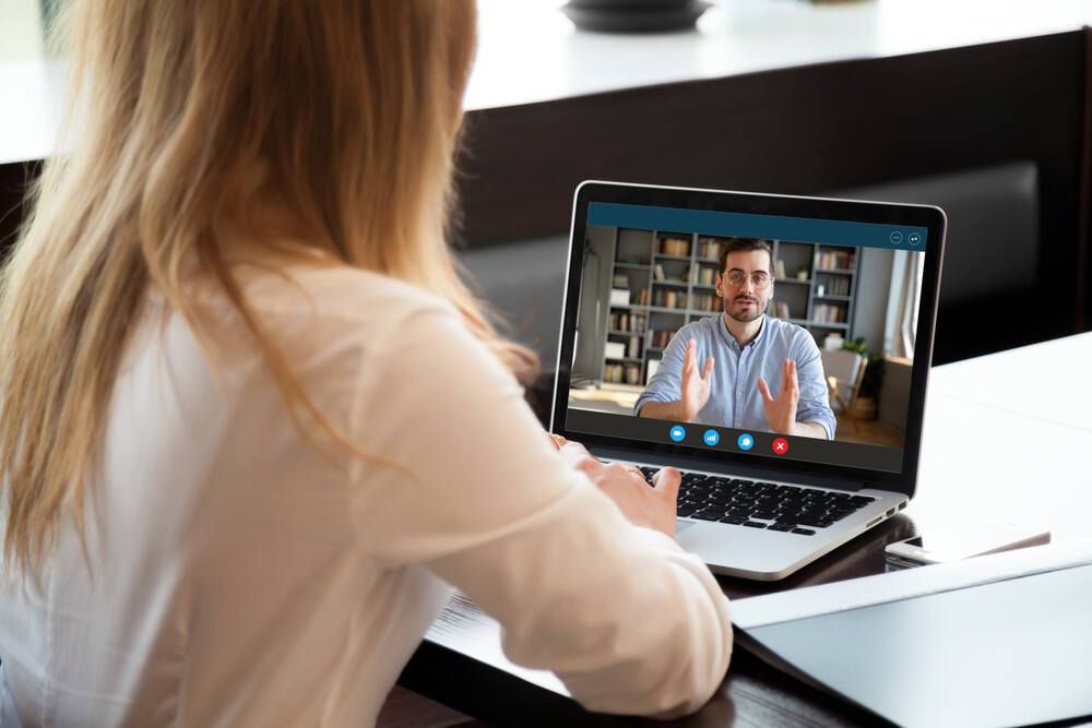 Woman having a virtual conference with a coworker